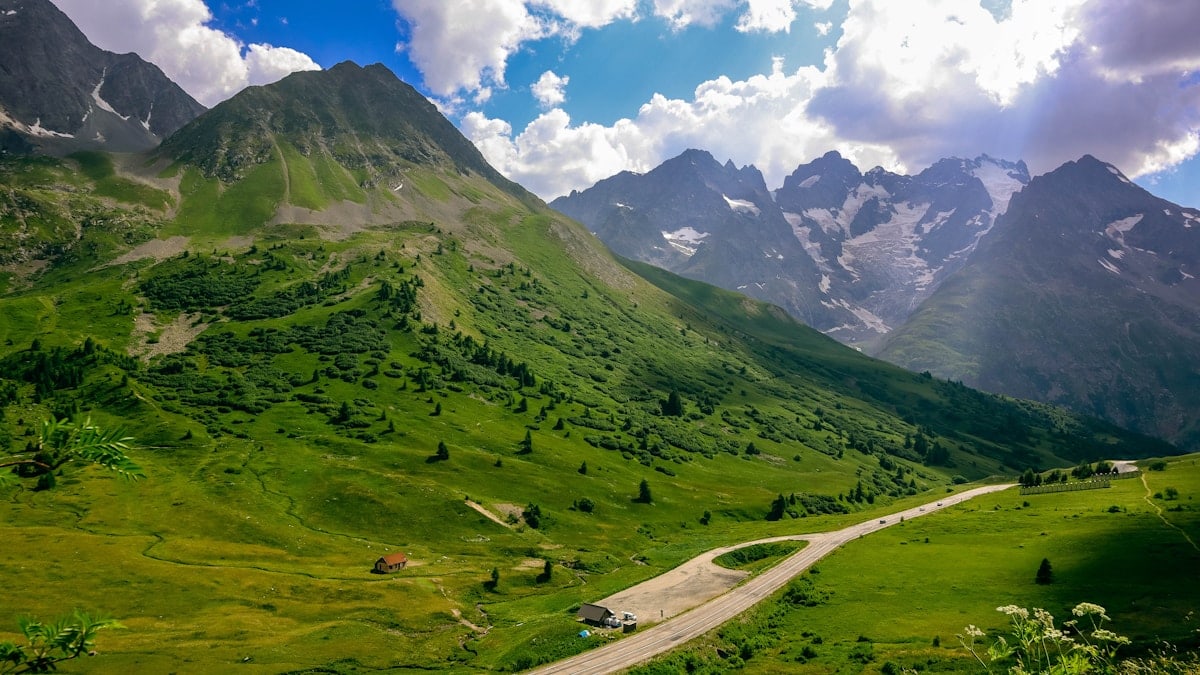 a road in a valley between mountains